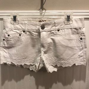 White jean shorts with floral detail